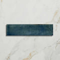 A rectangular navy blue ceramic tile with a textured matte finish from foundry porcelain blue collection