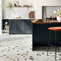 Frammento multi terrazzo effect porcelain tile with light speckled base and dark gray black brown beige stone fragments