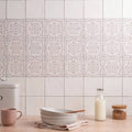 White ceramic frost field tile with delicate lace-like floral patterns used as a decorative backsplash