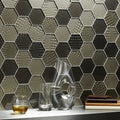 Futura Sepia Hexagon Mosaic grey and black reptile-textured hexagon mosaic with a glass carafe