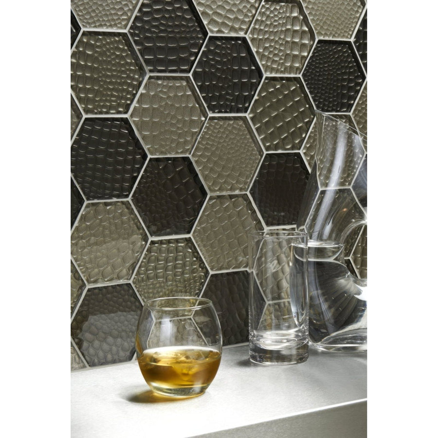 Futura Sepia Hexagon Mosaic grey and black hexagon mosaic with a faceted glass tumbler of amber liquid
