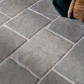 Gray stone-effect flooring tiles with subtle texture and white grout lines galway limestone cobble seasoned finish