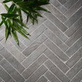 Gray stone tiles arranged in a herringbone pattern showcasing galway limestone seasoned parquet flooring