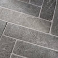 Gray stone tiles with rough textured surface and natural veining in galway limestone seasoned parquet flooring