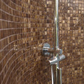 Gentle Earth 25mm Square iridescent gold mosaic behind a chrome shower tap