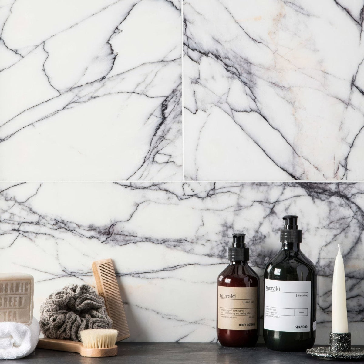 Georgica Pond Diamond Sawn Edge Polished white marble tiles with dark glass pump bottles on a countertop