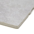 Giotto chalk gray stone tile with textured natural surface and irregularly cut edges for flooring or walls