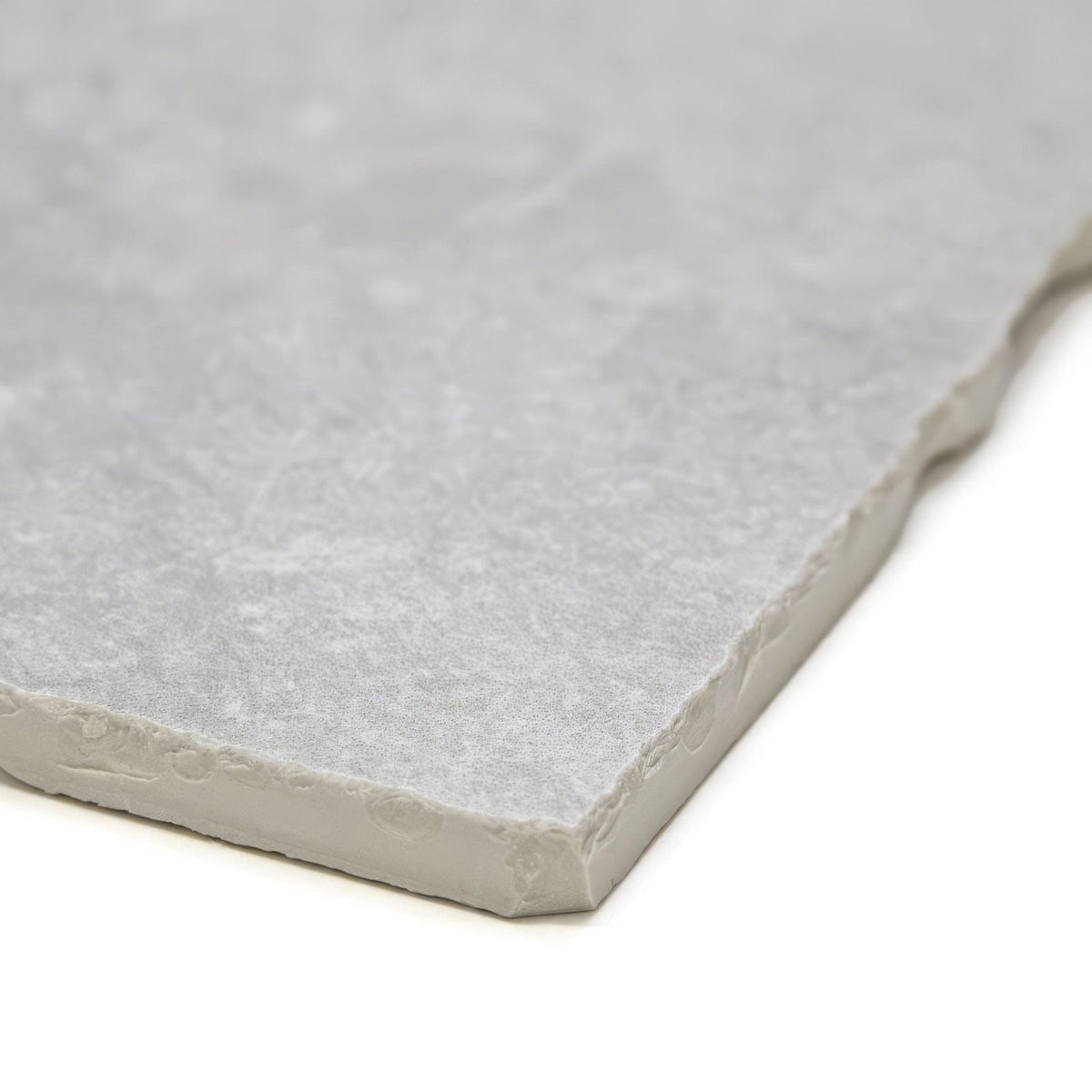 
Giotto chalk gray stone tile with textured natural surface and irregularly cut edges for flooring or walls