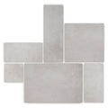 Giotto chalk gray concrete tiles arranged in a staggered pattern for modern flooring and wall applications
