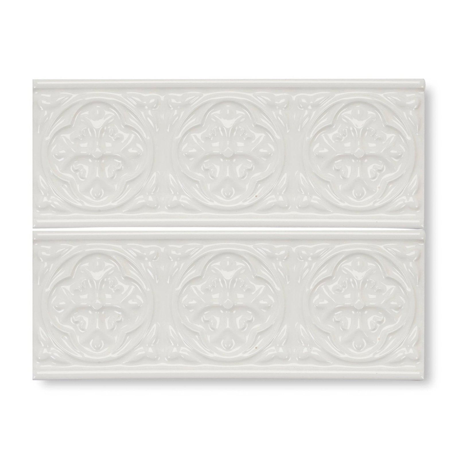 White ceramic subway tile with raised ornate floral patterns in giralda cascara cream border design