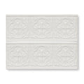 White ceramic subway tile with raised ornate floral patterns in giralda cascara cream border design