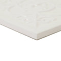 White ceramic tile with raised ornate floral embossing in cream color giralda cascara cream decor tile