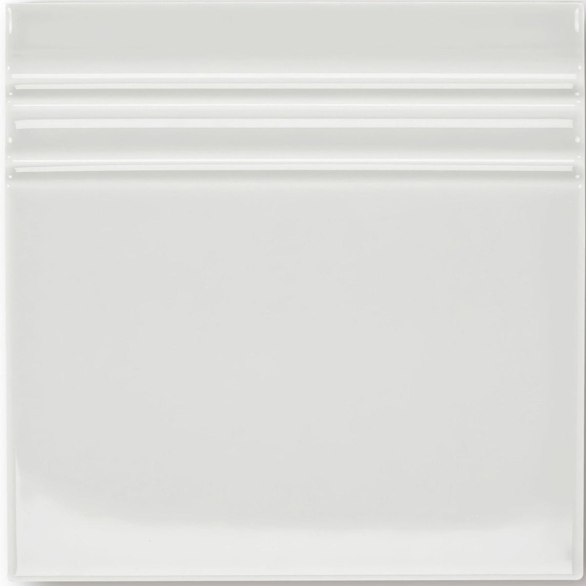 White ceramic giralda cascara cream skirting tile with a glossy finish and three horizontal ridges near the top
