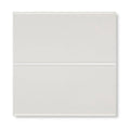 Two glossy white rectangular glass tiles stacked vertically from Giralda cascara cream tile collection