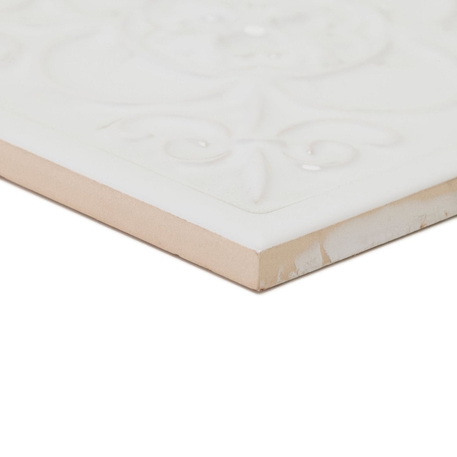 White ceramic giralda hielo decor tile with subtle embossed floral design and beige-colored edge