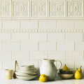 Cream-colored ceramic pitcher with a curved handle and subtle texture from Giralda Hielo white pencil collection