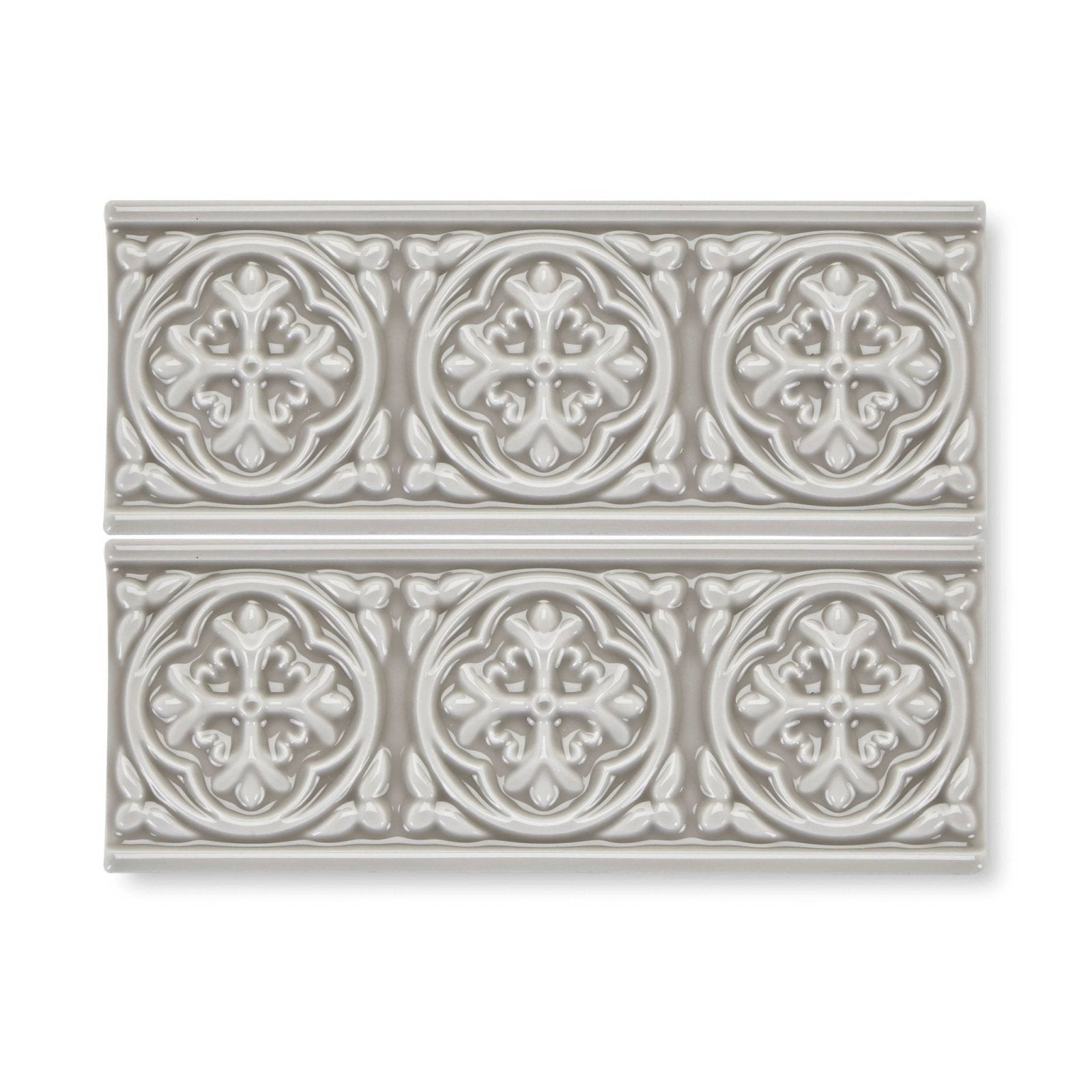 Gray ceramic tile giralda niebla grey border with raised ornate circular floral and leaf patterns