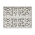Gray ceramic tile giralda niebla grey border with raised ornate circular floral and leaf patterns