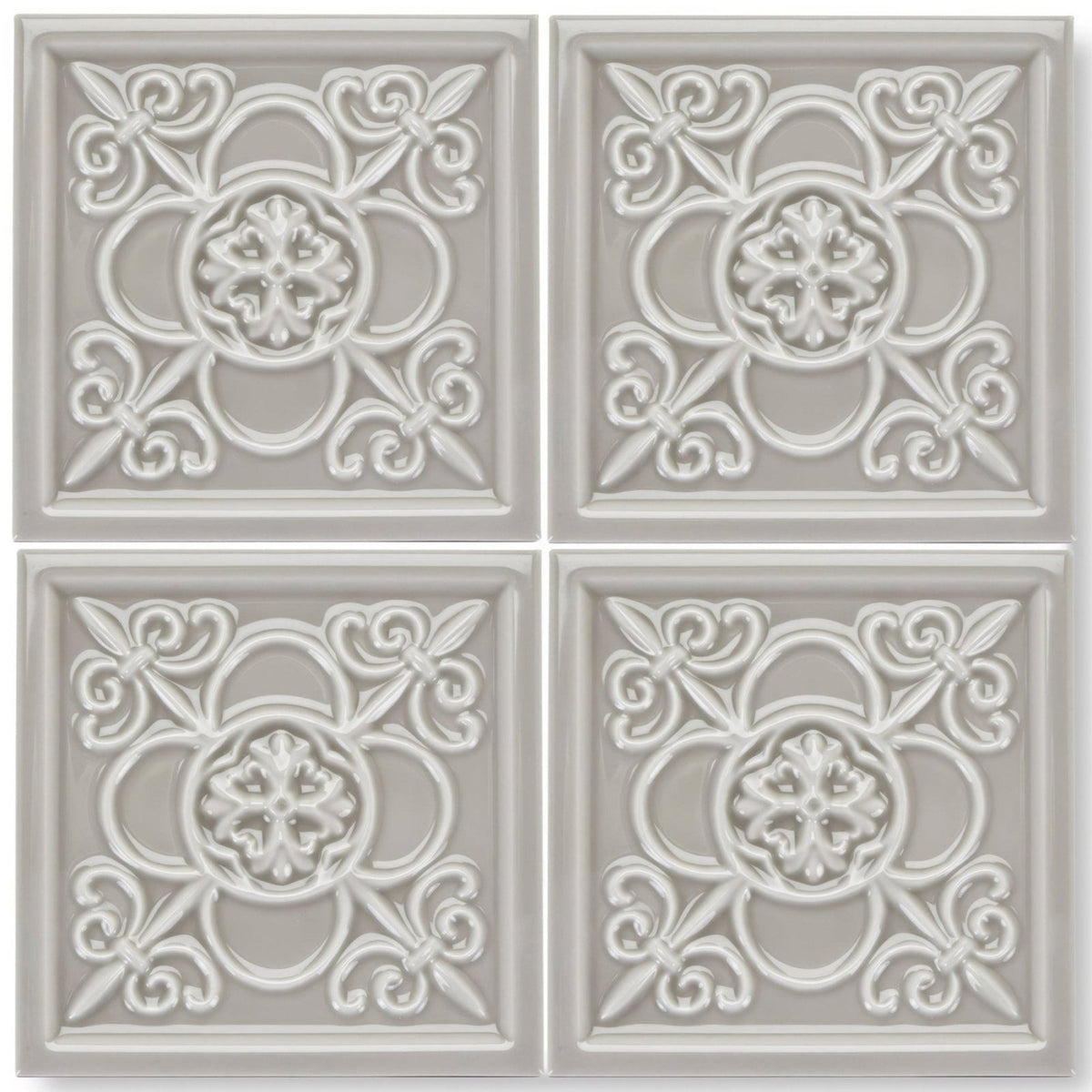 Set of four light gray ceramic giralda niebla grey decor tiles with raised ornate floral and scrollwork patterns