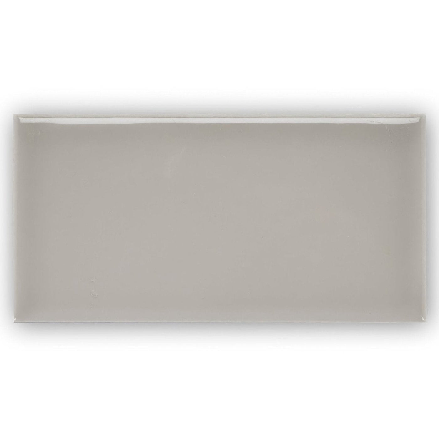 Giralda Niebla grey tile is a sleek rectangular ceramic tile with a smooth matte gray finish and subtle glossy edges