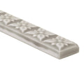 Gray ceramic tile giralda niebla grey trim with raised floral patterns along its length for decorative edging