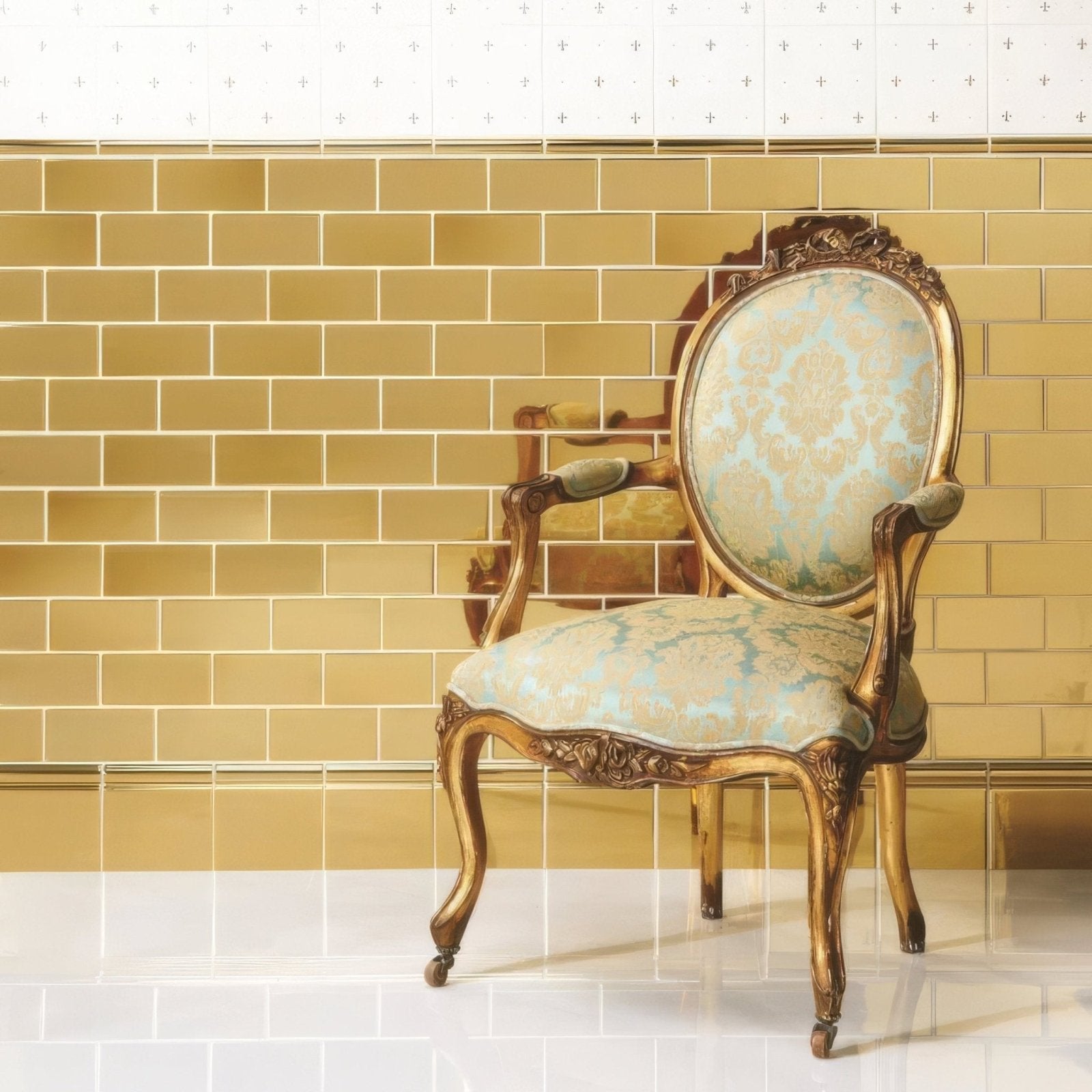 Antique armchair with gold finish ornate carvings and light blue damask upholstery displayed with gold metallic skirting tile