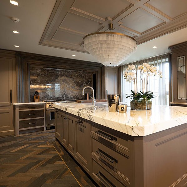 The Goodrich charred oak kitchen island features a sleek polished marble countertop with white and gray veining