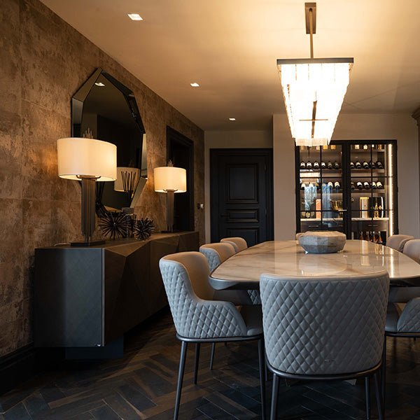 Gray quilted dining chairs with black metal legs in goodrich charred oak finish for elegant dining rooms