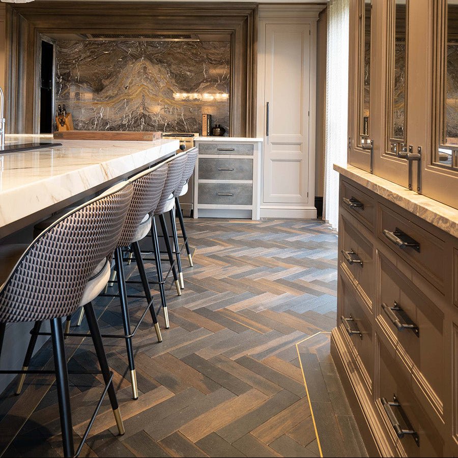 Modern kitchen featuring goodrich charred oak herringbone wood flooring and a marble backsplash
