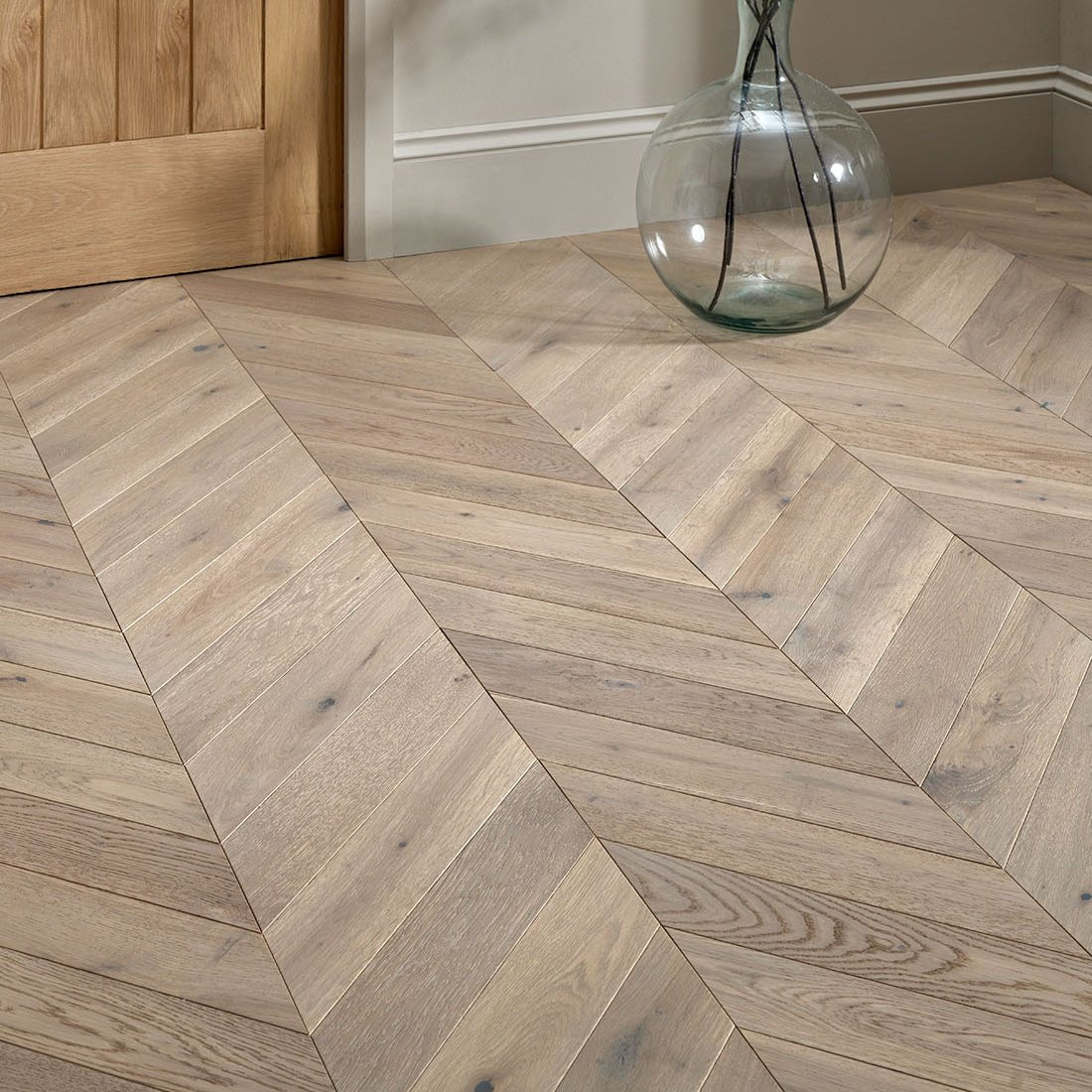 Light gray oak hardwood floor in a herringbone pattern from the goodrich feather oak chevron collection
