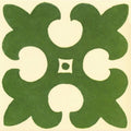 Green quatrefoil ceramic tile named gordon pale green on white with cream cutouts and central square detail