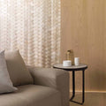 Gravity Aluminium Trace Gold Mosaic gold chevron aluminium mosaic with a round dark-framed side table