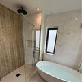 Gravity Aluminium Trace Gold Mosaic gold chevron aluminium mosaic with a white freestanding bathtub