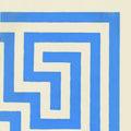 Blue and cream geometric patterned ceramic wall tile featuring greek key corner design on white background