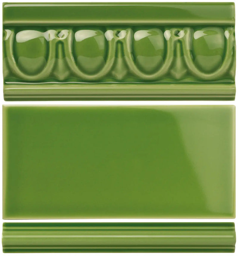 Green ceramic tile with a decorative, raised patterned border and a smooth, glossy finish.