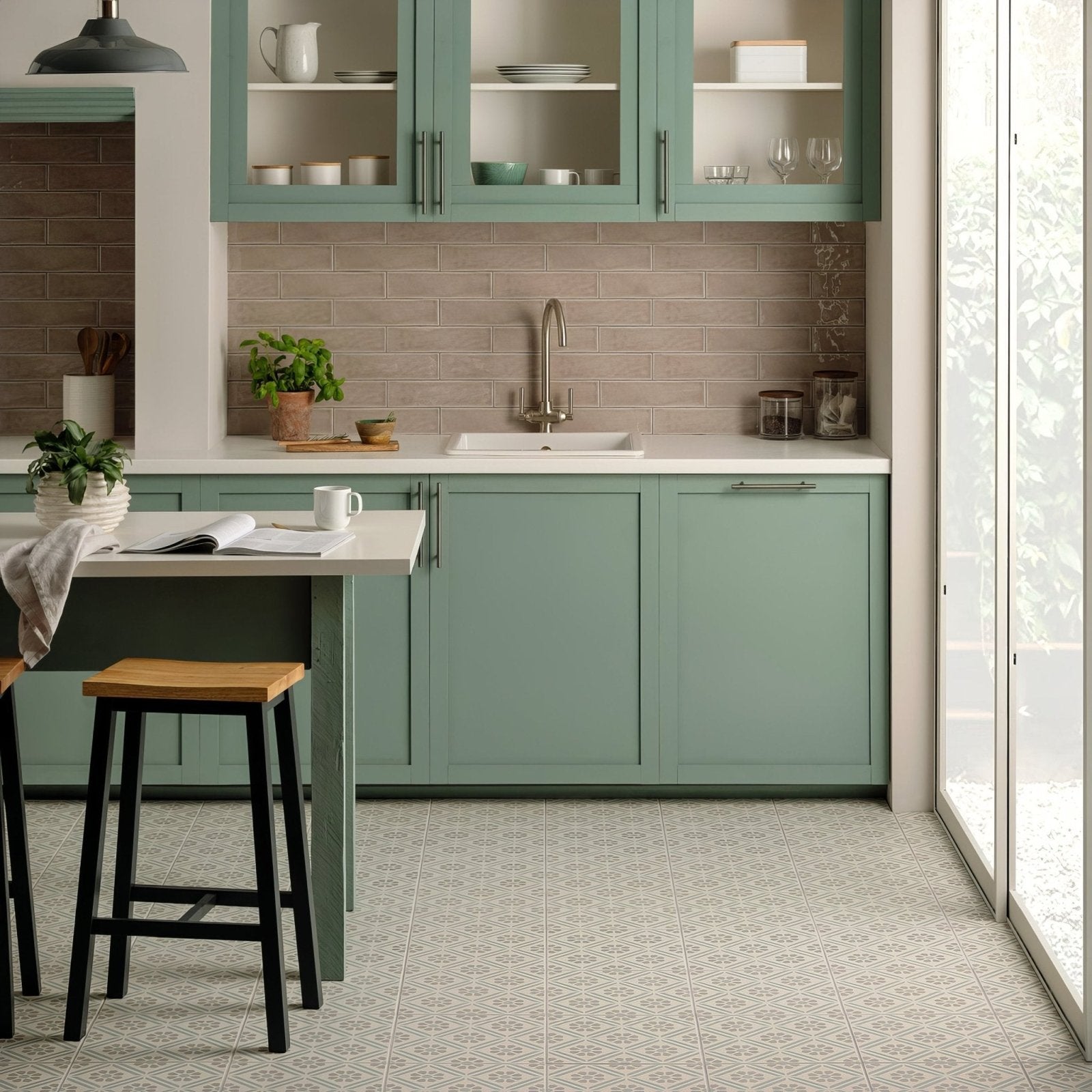 Mint green shaker-style kitchen cabinets with glass-front upper shelves and brushed metal handles in greenway teal on chalk