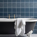 White waffle-weave towel draped over black clawfoot bathtub in grosvenor on ascot blue bathroom setting