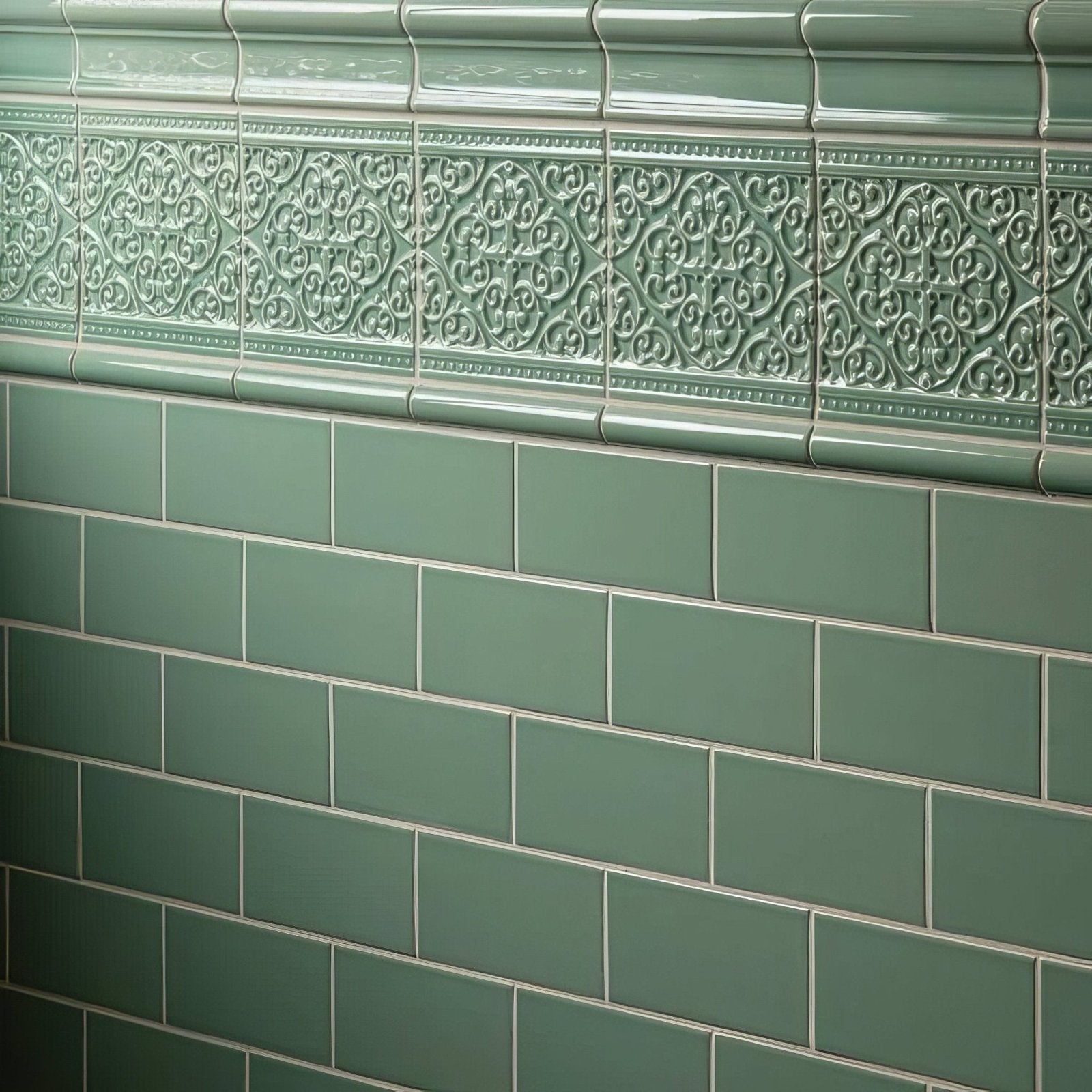 Grosvenor jade breeze green ceramic tiles with ornate raised floral patterns and plain rectangular tiles below