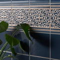 Dark blue ceramic grosvenor palladian beige tiles with cream ornamental patterns and beveled edges on ascot blue background