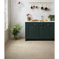 Dark green wychwood limestone velvet finish kitchen cabinet with gold toned knobs and white countertop