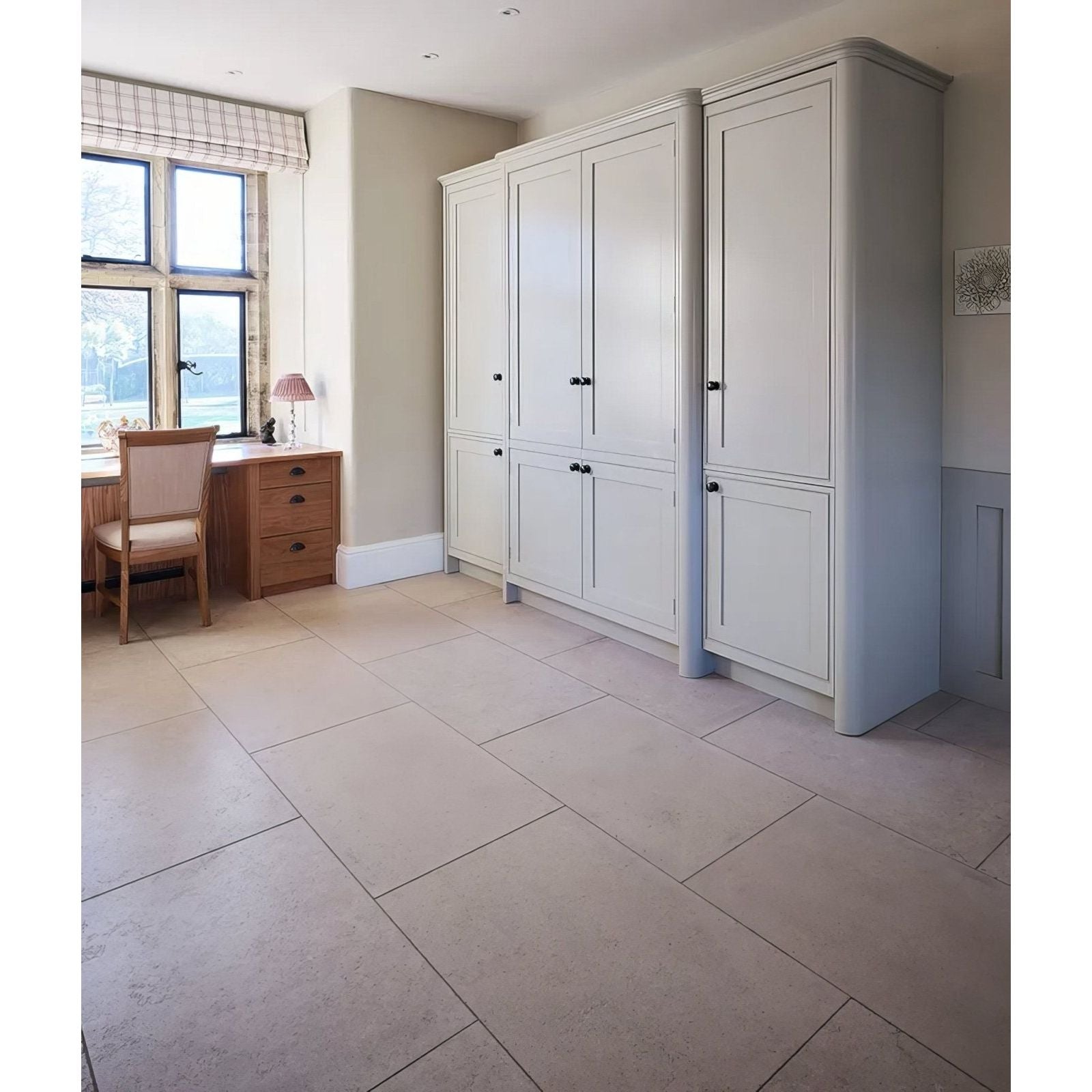 Cream-colored traditional wardrobe with black handles and paneled doors in wychwood limestone velvet finish