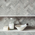 Hampton Bays Herringbone Mosaic grey stone herringbone mosaic with a clear glass bottle