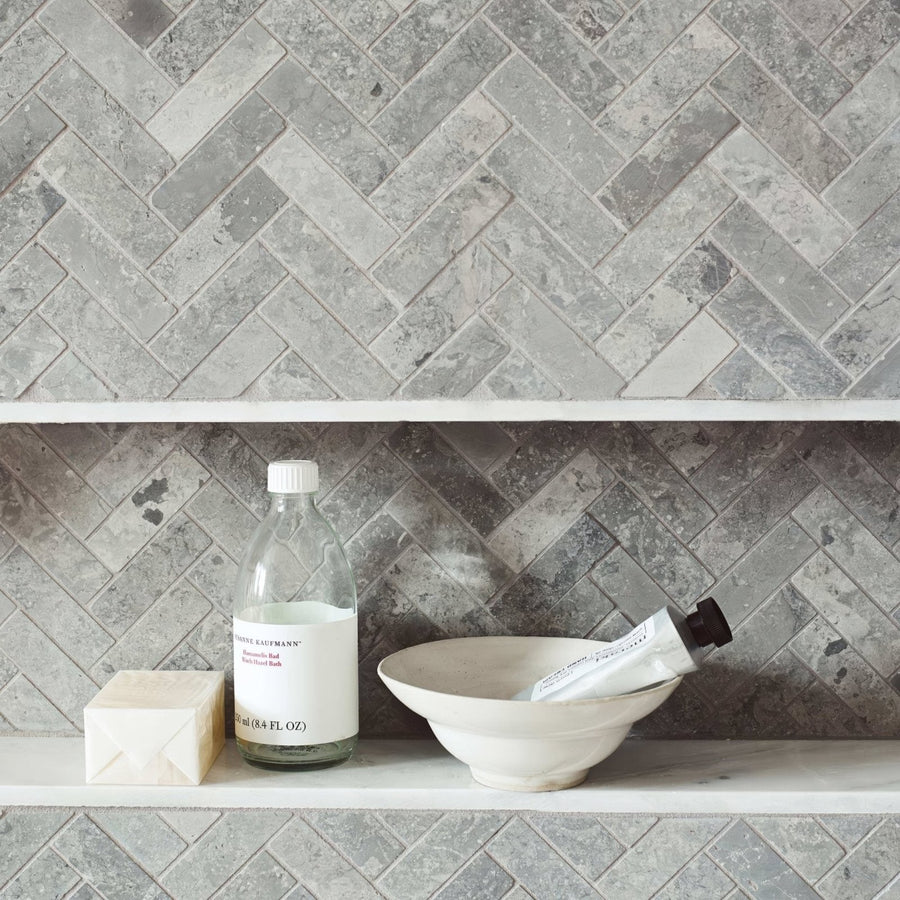 Hampton Bays Herringbone Mosaic grey stone herringbone mosaic with a clear glass bottle