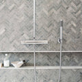 Hampton Bays Herringbone Mosaic grey stone herringbone mosaic with a chrome shower system
