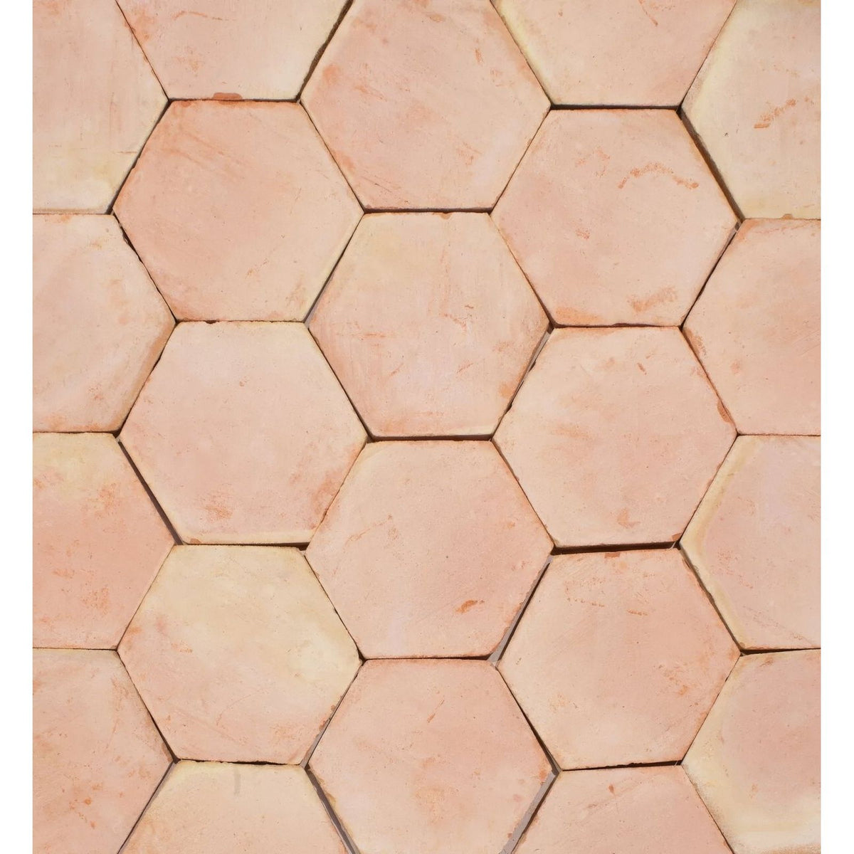 Handmade classic terracotta hexagonal floor tile in warm earthy tones with subtle natural color variations