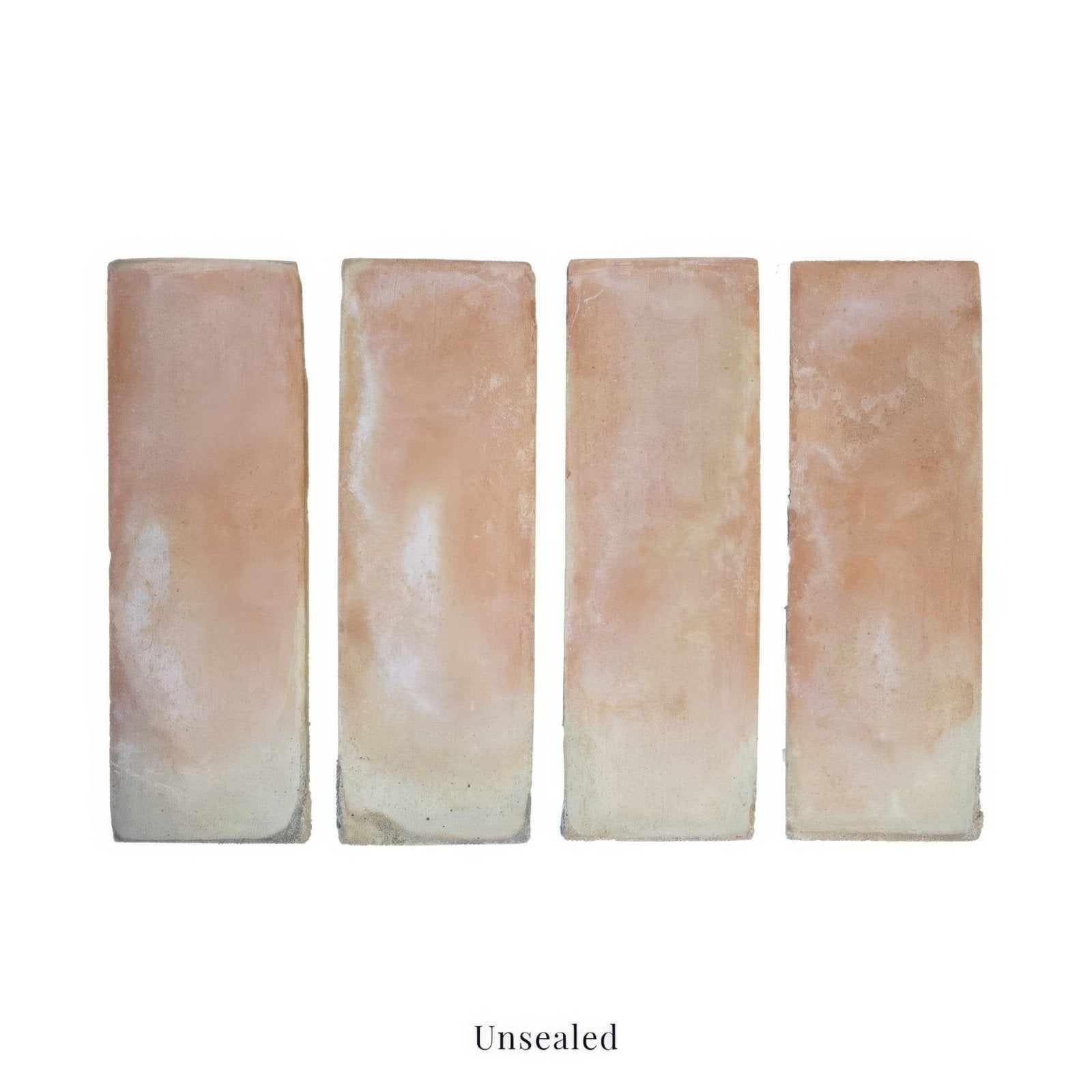 Four unsealed handmade classic terracotta rectangle tiles in warm beige and pinkish hues 10x30cm