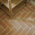Handmade classic terracotta rectangle tile 10x30cm with terracotta brick flooring in herringbone pattern and beige mortar