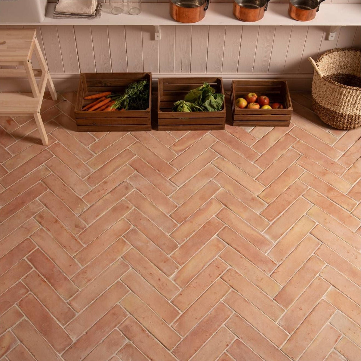 Handmade terracotta square floor tiles 20 x 20 cm with herringbone pattern in warm terracotta color