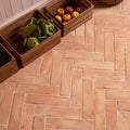 Handmade terracotta square floor tiles with a herringbone pattern in 20 x 20cm size for stylish flooring