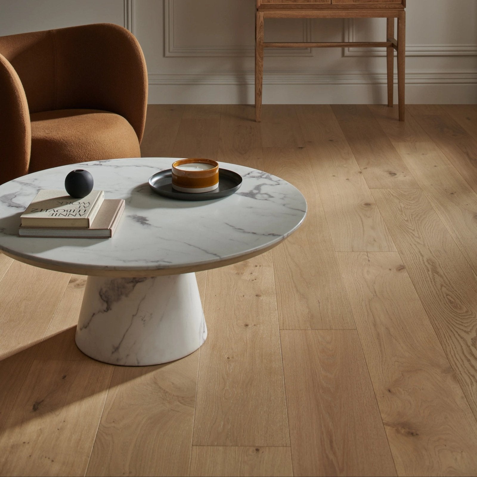 Harlech raw oak sleek round marble coffee table with white base and gray veining for stylish living room use